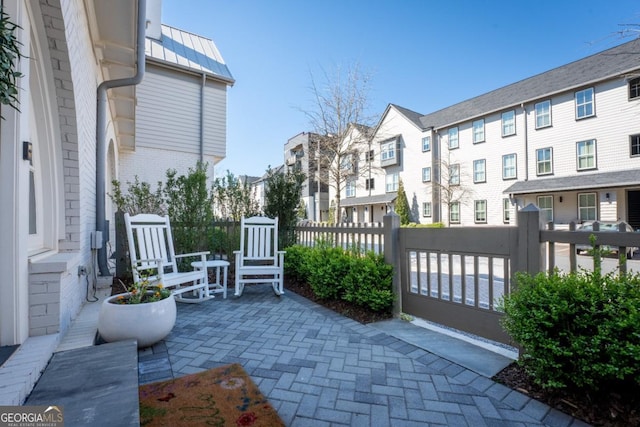 view of patio with a residential view and fence