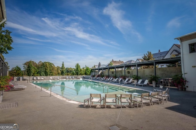 community pool with a patio area