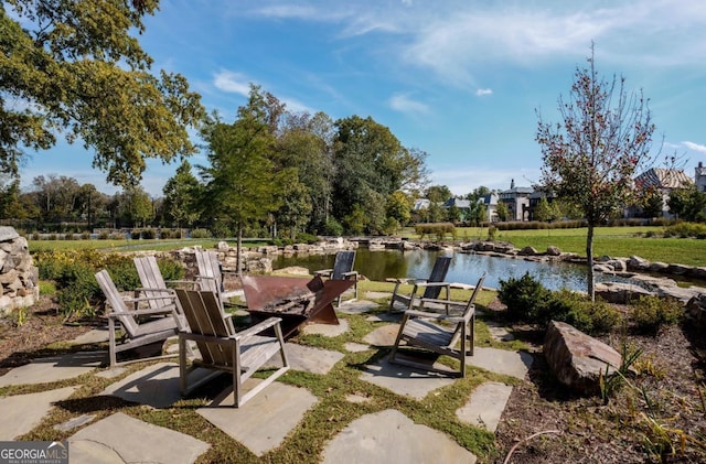 view of patio with a water view and a boat dock