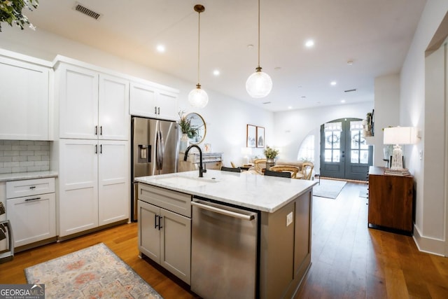 kitchen with visible vents, french doors, stainless steel appliances, and wood finished floors