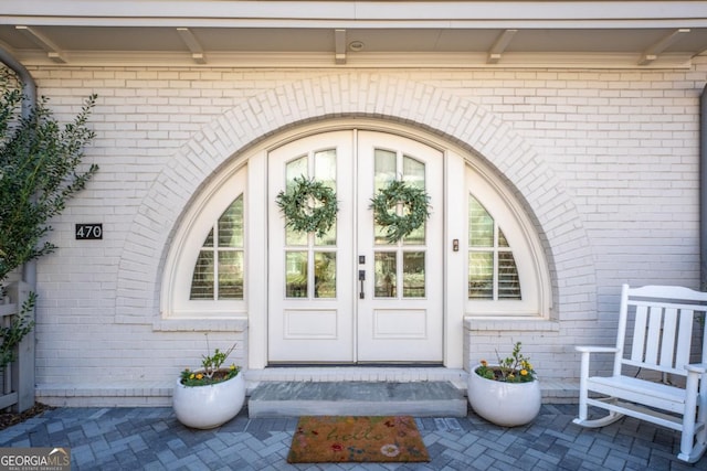 entrance to property with french doors and brick siding