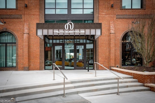 view of exterior entry with brick siding