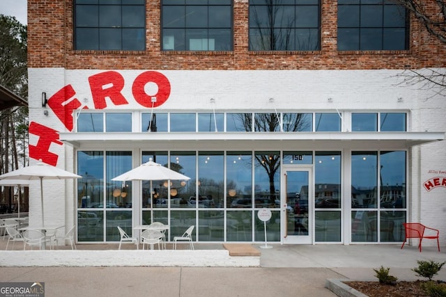 view of exterior entry featuring brick siding