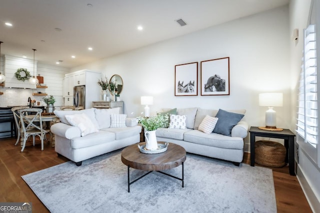 living room featuring dark wood finished floors, visible vents, and recessed lighting