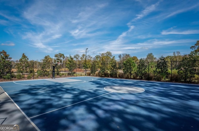 view of basketball court with community basketball court and fence