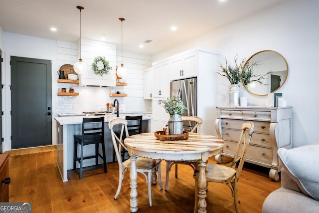 dining room featuring recessed lighting and wood finished floors