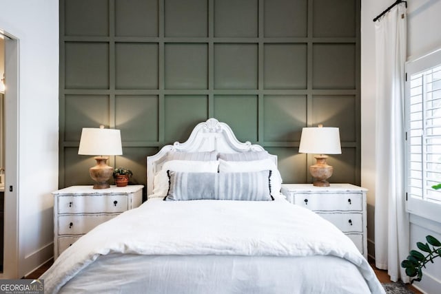 bedroom featuring a decorative wall