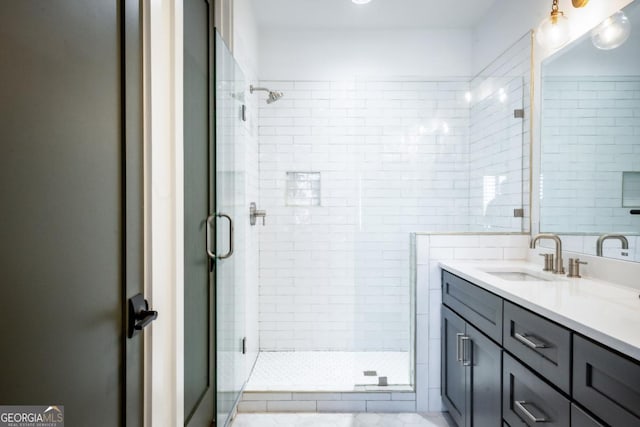 bathroom with vanity and a stall shower