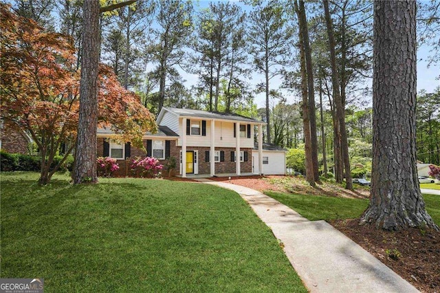 view of front of property with a front lawn and brick siding