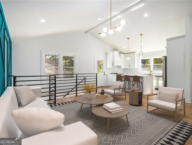 living area featuring beam ceiling, recessed lighting, light wood-style floors, and high vaulted ceiling