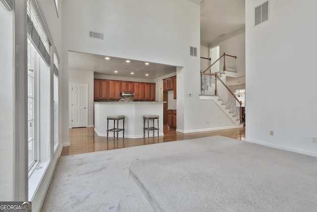 41 Eastlake Lndg, Newnan, GA 30265 - living room with carpet flooring, plenty of natural light, a high ceiling, stairway, and recessed lighting