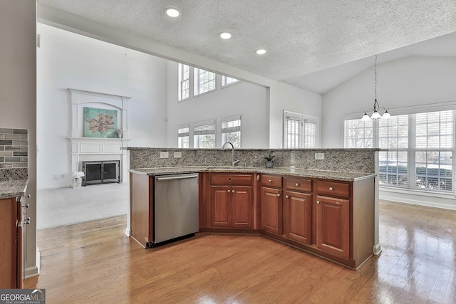 41 Eastlake Lndg, Newnan, GA 30265 - kitchen featuring dishwasher, healthy amount of natural light, light wood-type flooring, a textured ceiling, and a chandelier