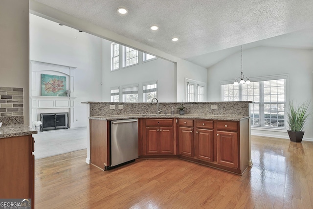 41 Eastlake Lndg, Newnan, GA 30265 - kitchen featuring stainless steel dishwasher, high vaulted ceiling, a textured ceiling, a chandelier, and light wood-style floors
