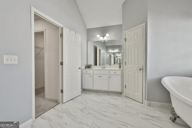 41 Eastlake Lndg, Newnan, GA 30265 - full bath featuring a freestanding tub, marble look tile flooring, vanity, a spacious closet, and vaulted ceiling