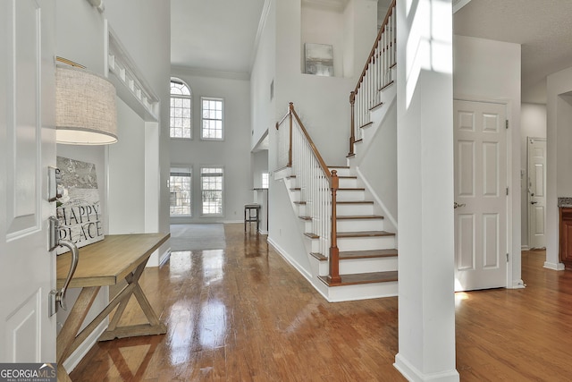 41 Eastlake Lndg, Newnan, GA 30265 - foyer entrance featuring stairway, wood finished floors, a high ceiling, and crown molding