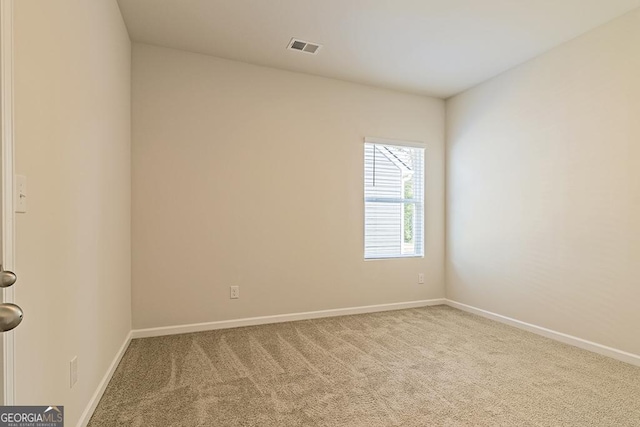 spare room with baseboards, visible vents, and carpet floors