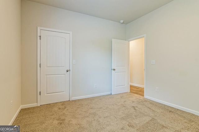 unfurnished bedroom with carpet flooring and baseboards