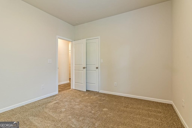 unfurnished bedroom featuring baseboards and carpet floors