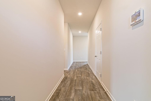 hallway with recessed lighting, baseboards, and dark wood-style flooring