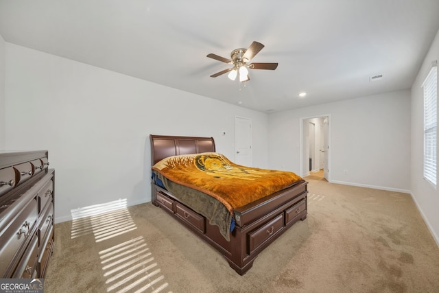 bedroom featuring visible vents, baseboards, light colored carpet, and ceiling fan