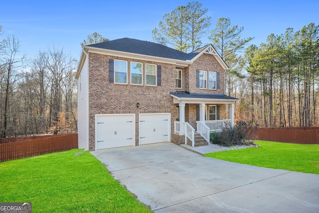 view of front of property featuring a front lawn, a porch, fence, and driveway