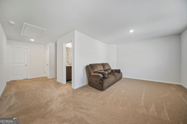 unfurnished room with baseboards, light colored carpet, and attic access