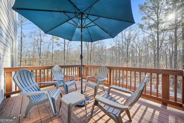 wooden deck with a forest view