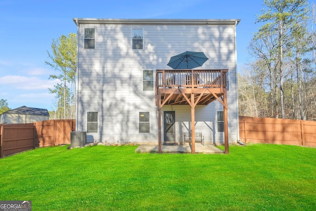 back of property featuring a yard, a fenced backyard, and a patio area