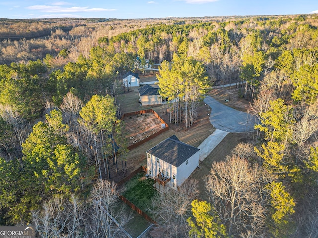 aerial view featuring a wooded view