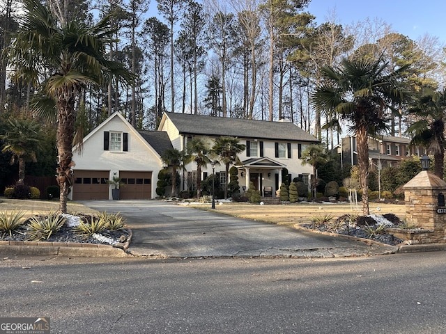 view of front of home with a garage and aphalt driveway