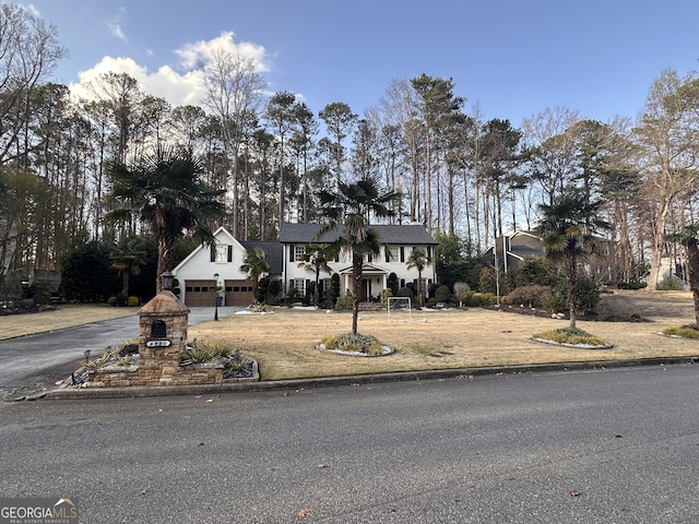 view of front of property featuring aphalt driveway and a garage