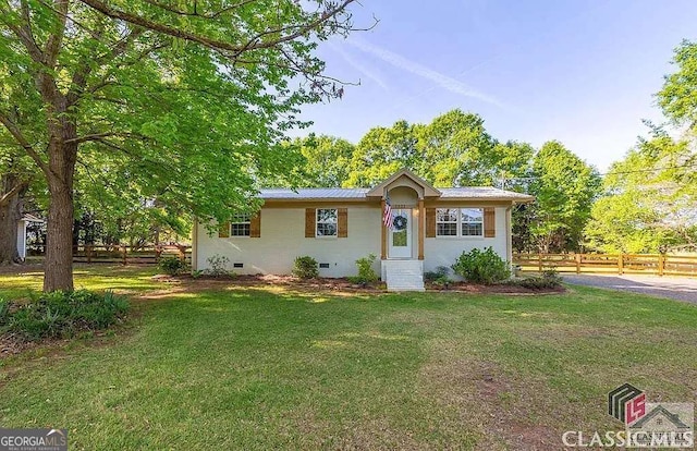 ranch-style house with a front yard, fence, and crawl space