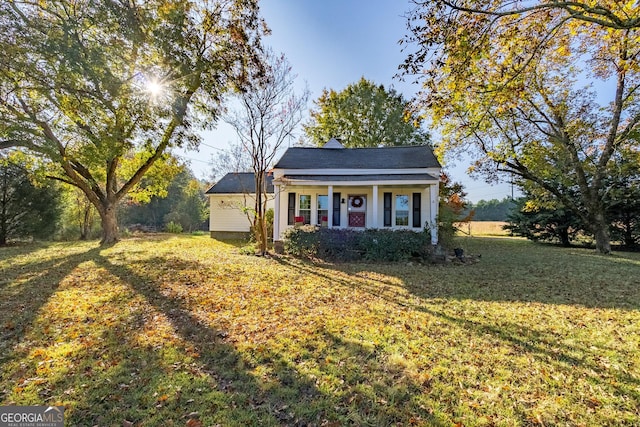 bungalow-style house with a front lawn