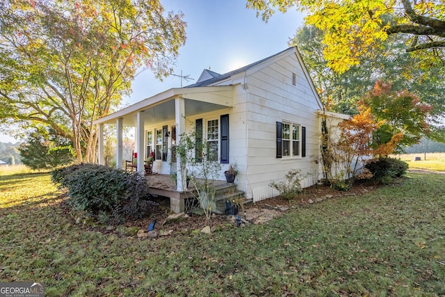 bungalow-style house featuring a porch and a front lawn