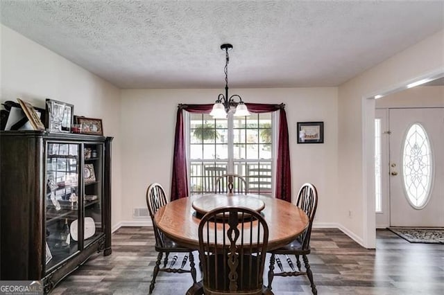 144 Bobs Dr, Mableton, GA 30126 - dining space with a textured ceiling, dark wood-style floors, and a chandelier