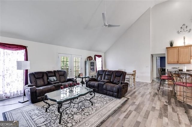 144 Bobs Dr, Mableton, GA 30126 - living room featuring light wood-style flooring, high vaulted ceiling, and a ceiling fan