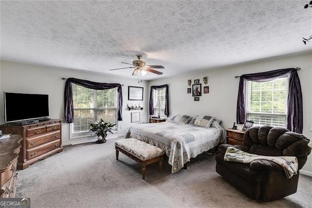 144 Bobs Dr, Mableton, GA 30126 - carpeted bedroom featuring a textured ceiling, multiple windows, and ceiling fan