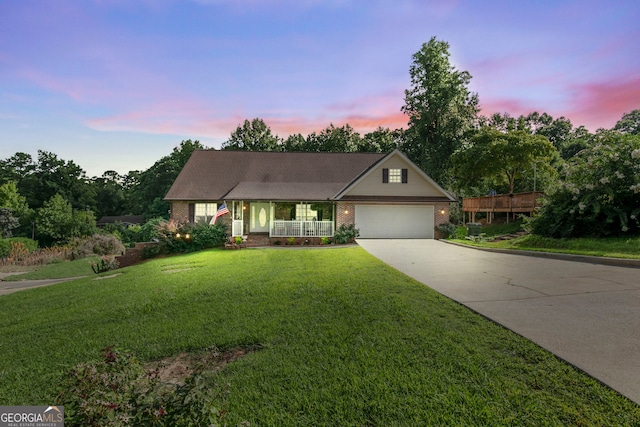 144 Bobs Dr, Mableton, GA 30126 - view of front facade featuring an attached garage, covered porch, concrete driveway, a lawn, and brick siding