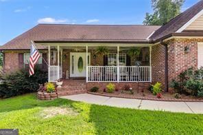 144 Bobs Dr, Mableton, GA 30126 - view of front of property with brick siding, a porch, and a front yard