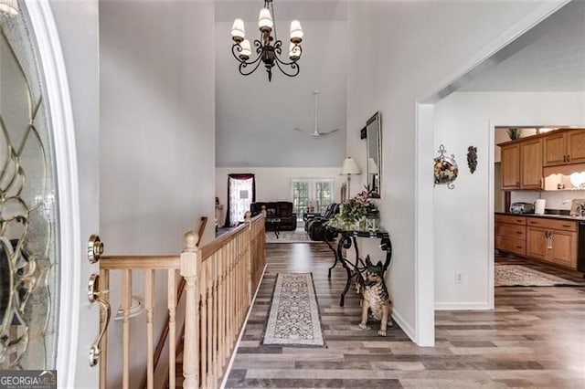 144 Bobs Dr, Mableton, GA 30126 - foyer entrance featuring a notable chandelier, a high ceiling, baseboards, and wood finished floors