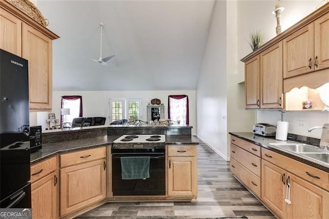 144 Bobs Dr, Mableton, GA 30126 - kitchen featuring range with electric cooktop, light brown cabinetry, a sink, dark countertops, and lofted ceiling