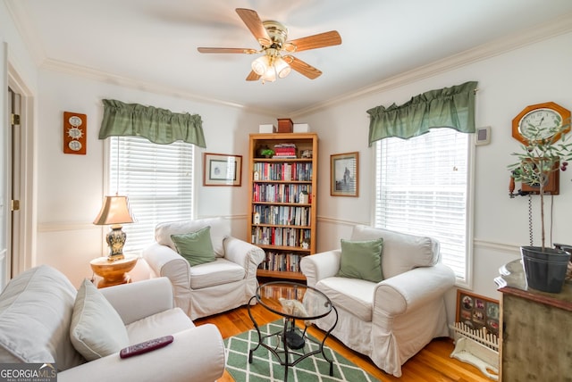 1650 Pierce Dairy Rd, Madison, GA 30650 - living area featuring a ceiling fan, wood finished floors, and ornamental molding