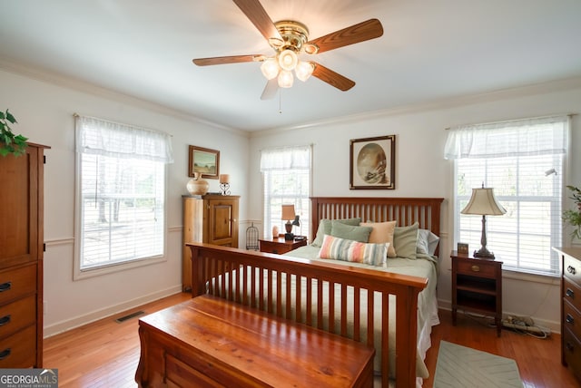 1650 Pierce Dairy Rd, Madison, GA 30650 - bedroom featuring crown molding, visible vents, baseboards, and light wood-style floors