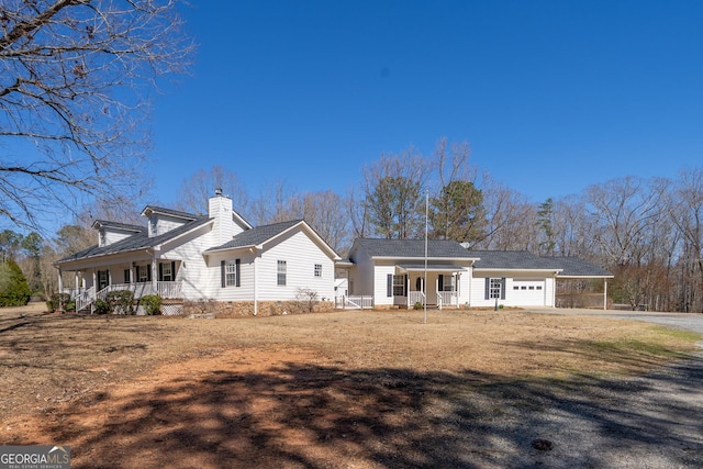 1650 Pierce Dairy Rd, Madison, GA 30650 - back of property with a carport, covered porch, a garage, and driveway