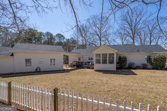 1650 Pierce Dairy Rd, Madison, GA 30650 - back of property featuring a sunroom, a deck, fence private yard, and a lawn