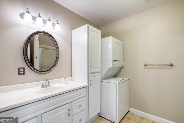 1650 Pierce Dairy Rd, Madison, GA 30650 - bathroom with tile patterned floors, stacked washing maching and dryer, baseboards, and vanity