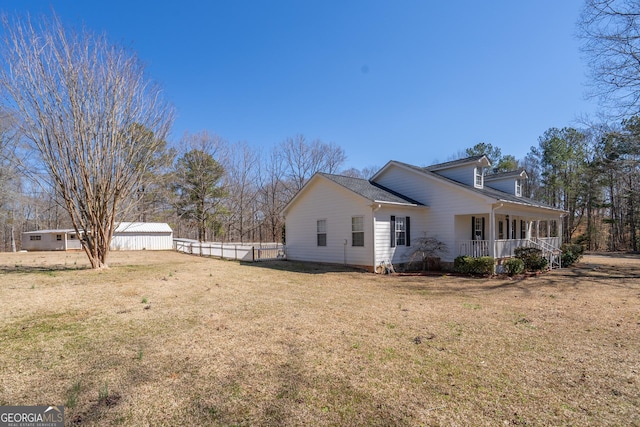 1650 Pierce Dairy Rd, Madison, GA 30650 - view of side of home featuring covered porch, fence, and a lawn