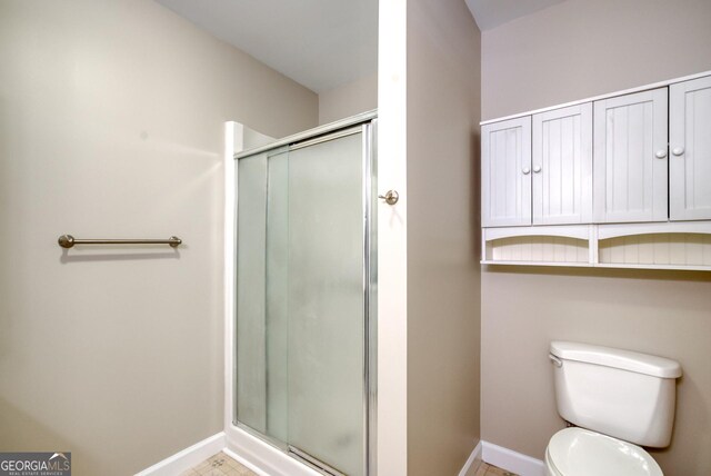 1650 Pierce Dairy Rd, Madison, GA 30650 - full bathroom with a shower stall, baseboards, and toilet