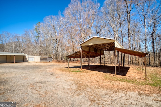 1650 Pierce Dairy Rd, Madison, GA 30650 - exterior space with an outbuilding, a detached garage, and dirt driveway