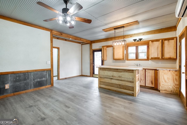 1650 Pierce Dairy Rd, Madison, GA 30650 - kitchen featuring ceiling fan, a wall unit AC, light countertops, decorative light fixtures, and light wood finished floors